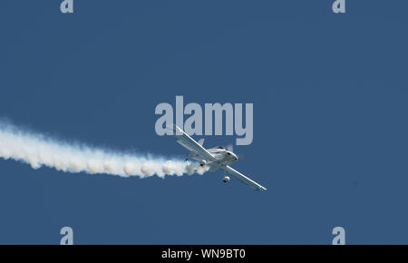 Clacton   United Kingdom 23 August  2019  -:  Stunt plane trailing white smoke at Clacton Airshow Stock Photo