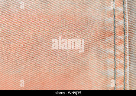 Orange color old denim texture close up. Textile background Stock Photo