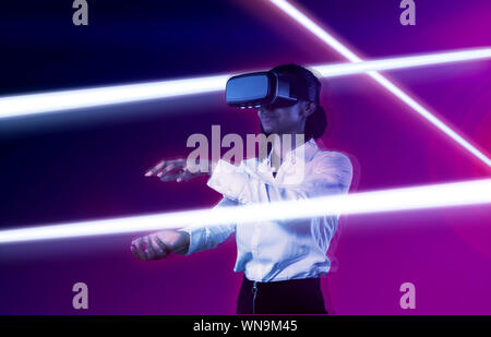 Composite image of woman using virtual reality headset. Stock Photo