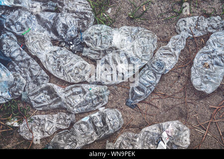 old crushed plastic bottles lying on the floor Stock Photo