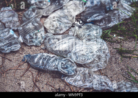old crushed plastic bottles lying on the floor Stock Photo