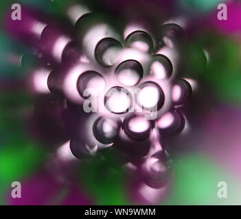 Unusual top view of many multicolored plastic cocktail tubes. Drinking straws of bright purple and green colors. Eco concept Stock Photo