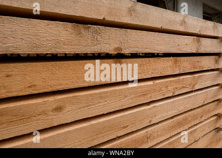 cleanly stored wooden beams fresh from sawing Stock Photo