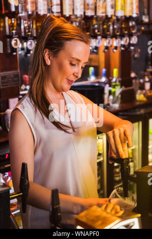 England, London, Southwark, Bermondsey, Barmaid In the Anchor Tap Sam Smiths Pub Stock Photo