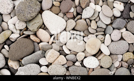 Naturally polished white rock pebbles background - Sea stones Stock Photo