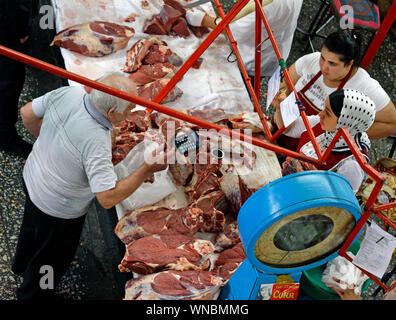 Almaty, Kazakhstan - August 22, 2019: People in the meat section of the famous Green Bazaar of Almaty, Kazakhstan. Stock Photo