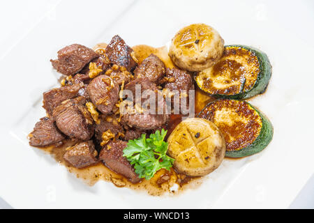 Stir fried beef served with mushroom, zucchini and soy sauce Stock Photo