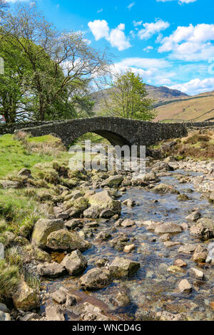 Picturesque bridge over a stream at the point of joining Hardknott Pass from Wrynose Pass, on the way to Scarfell Pike, Lake District, Cumbria, UK Stock Photo