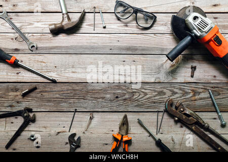 Flat lay composition with vintage carpentry tools on rough wooden background. Top view workbench with carpenter different tools. Woodworking, craftsma Stock Photo
