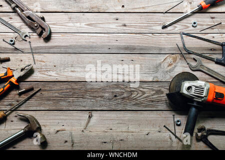 Flat lay composition with vintage carpentry tools on rough wooden background. Top view workbench with carpenter different tools. Woodworking, craftsma Stock Photo