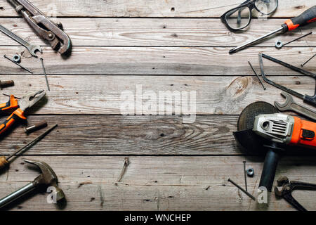 Flat lay composition with vintage carpentry tools on rough wooden background. Top view workbench with carpenter different tools. Woodworking, craftsma Stock Photo