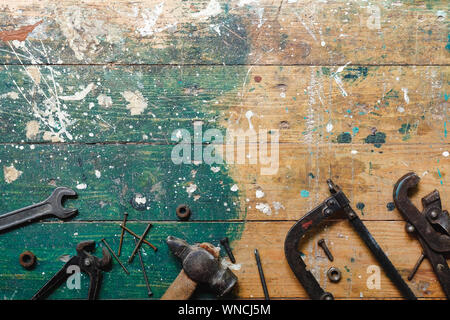 Flat lay set of vintage carpentry tools on colorful wooden background. Top view workbench with carpenter different tools. DIY, woodworking, craftsmans Stock Photo
