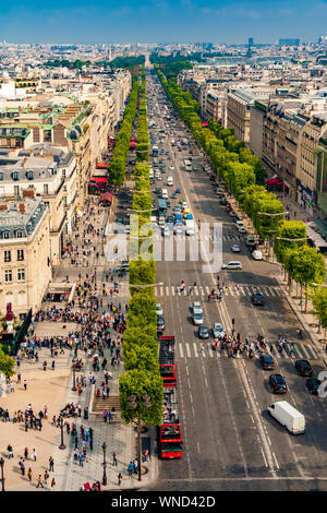 Great aerial portrait view of the famous Avenue des Champs-Élysées in Paris on a nice sunny day with a blue sky at the horizon. People walking along... Stock Photo