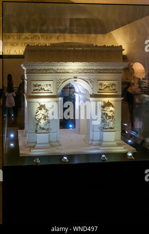 The illuminated display model of the Arc de Triomphe in a glass cabinet inside the famous Arc de Triomphe monument in Paris. Stock Photo