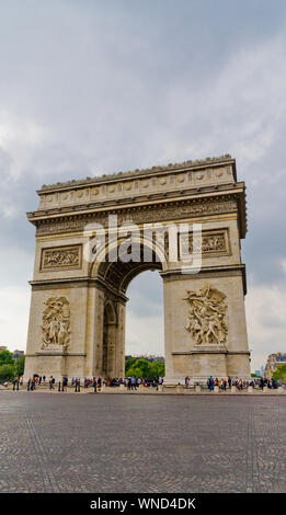 Nice portrait view of the famous monument Arc de Triomphe in Paris, seen from the east with the two sculptures Le Départ and Le Triomphe on a cloudy,... Stock Photo