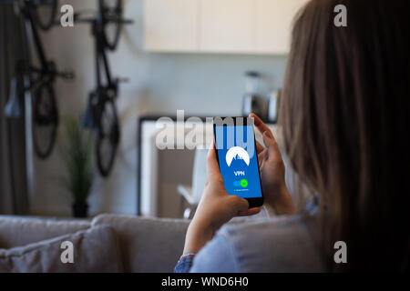 Privacy consider girl uses a security app on her phone Stock Photo