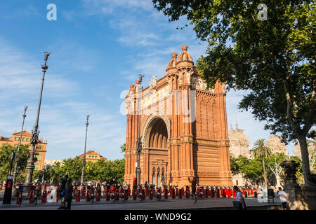 BARCELONA - JUNE 19, 2019: Pedestrians walking in front of the amazing Triumphal Arch, located in Barcelona, Spain, Europe Stock Photo