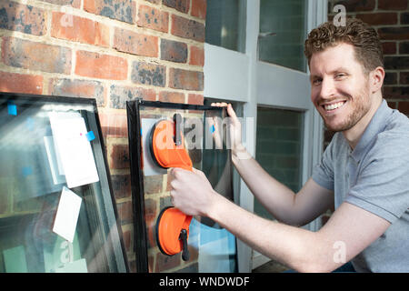 Portrait Of Construction Worker Preparing To Fit Glass Into New Windows Stock Photo