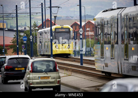 Metrolink tram in Ashton-under-Lyne passing the Ashton Moss Leisure Park Stock Photo