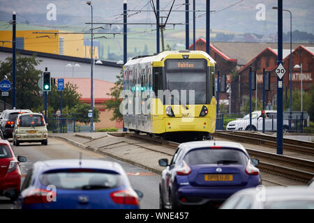 Metrolink tram in Ashton-under-Lyne passing the Ashton Moss Leisure Park Stock Photo