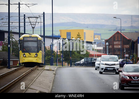 Metrolink tram in Ashton-under-Lyne passing the Ashton Moss Leisure Park with Ikea behind Stock Photo