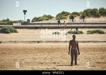 Statue, Another Place by Anthony Gormley Crosby Beach River Mersey estuary Sefton, Merseyside, England. Stock Photo