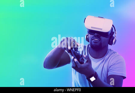 Composite image of man using virtual reality headset and playing video game Stock Photo