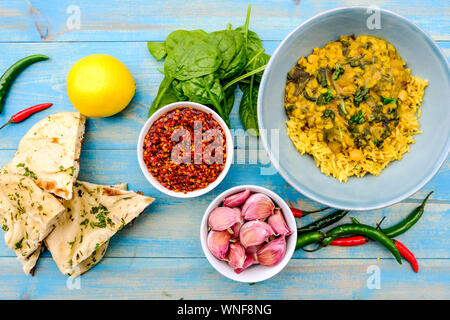 Indian Vegetarian Lentil and Spinach Curry With Pilau Yellow Rice Stock Photo