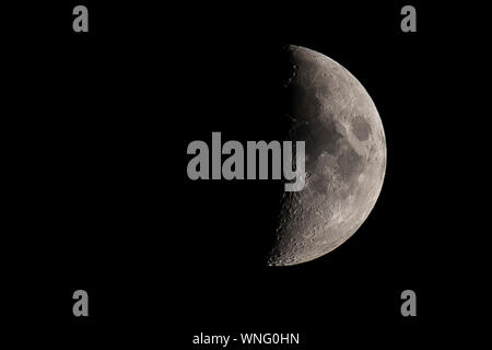Crescent half moon, first quarter. Black sky, serene weather. Wallpaper with Left copy space. Stock Photo
