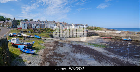 Boats and harbour of the coastal fishing village of Craster on the Northumberland coast in North East England Stock Photo