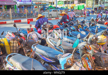 TAUNGGYI, MYANMAR - FEBRUARY 20, 2018: The dense parked bikes by the road at the city agricultural market, on February 20 in Taunggyi. Stock Photo