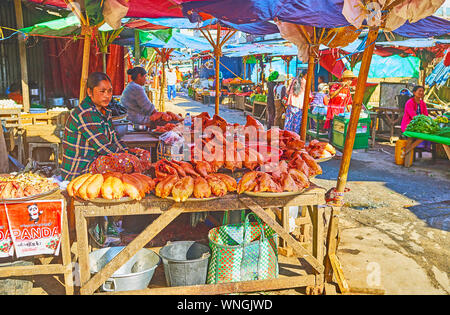 TAUNGGYI, MYANMAR - FEBRUARY 20, 2018: The voutdoor stalls of farmers market with large amount of fresh chicken, on February 20 in Taunggyi. Stock Photo