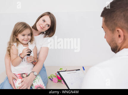 mother with her daughter at doctor office. Parent with one child visiting pediatr Stock Photo