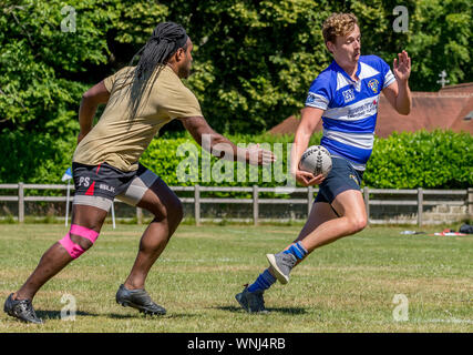 Amateur rugby touch player (male, 19 y) evades touch tackle Stock Photo
