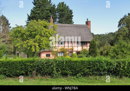 Traditional Thatched English timber framed Village Cottage and garden Stock Photo