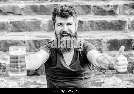 drink alcoholic beer beverage. weekend relax. Mature hipster with beard hair drinking beer. Bearded man with beer glass outdoor. brutal male needs refreshment. Quench your thirst. Stock Photo