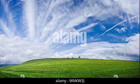 Wide panoramic view of blue skies above green fields in the Peak District, England. Stock Photo