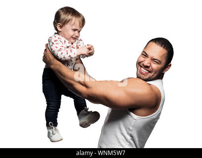 Father Holding Crying Daughter While Standing Against White Background
