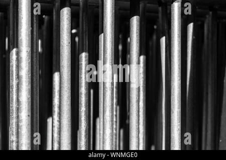 Vertical steel bars from street barricades stacked in front of each other Stock Photo