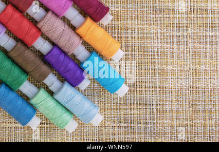 Multicolored sewing threads. Spools of thread for sewing. The concept of sewing accessories. Stock Photo