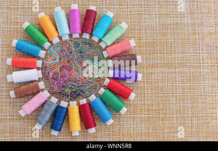 Multicolored sewing threads. Spools of thread for sewing. The concept of sewing accessories. Stock Photo