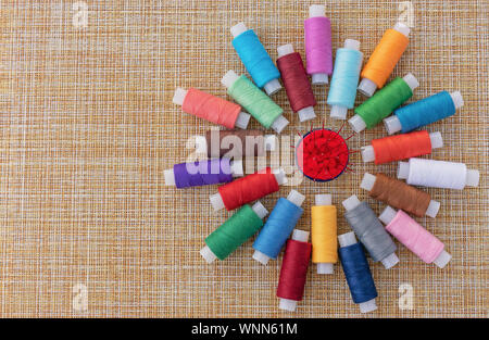 Multicolored sewing threads. Spools of thread for sewing. The concept of sewing accessories. Stock Photo