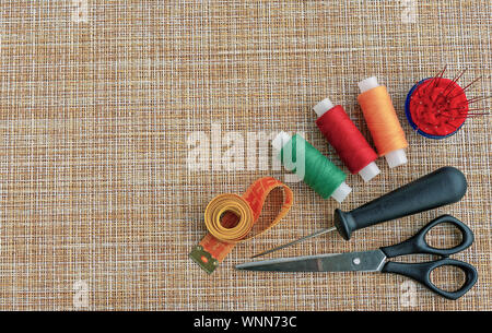 Sewing threads and other accessories for sewing and needlework. The concept of sewing accessories. Stock Photo