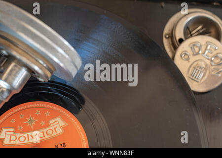 Berlin, Germany - April 1, 2019: Focus on the label of a historical shellac disc by Polydor with blurred parts of an old gramophone from Germany in th Stock Photo