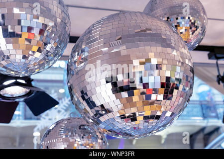 Mirror disco balls and a searchlight on a New Year's background. Stock Photo