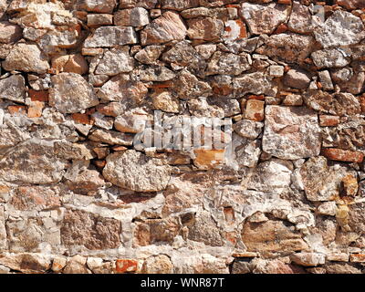 Rough wall made of natural stone and boulders Stock Photo