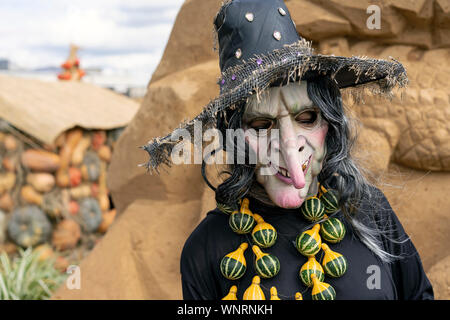 Figure of a gray-haired witch with pumpkin beads. Stock Photo