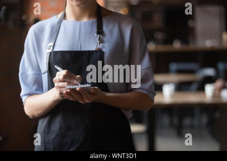 Close up attractive waitress ready to take order in coffeehouse Stock Photo