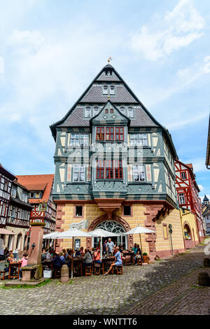 8 August 2019: Oldest Hotel from1158  (alteste Gasthaus Deutschlands), half-timbered houses, restaurant, shops, peaple in old german town Miltenberg a Stock Photo