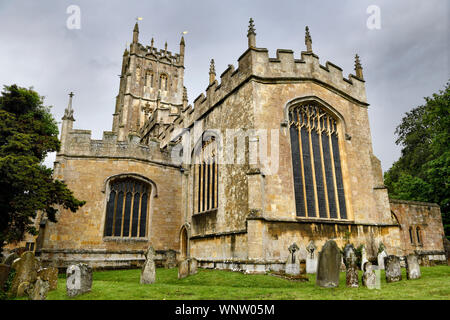 Outside of East Window of St James Church from cemetery under cloudy sky in Chipping Campden England Stock Photo
